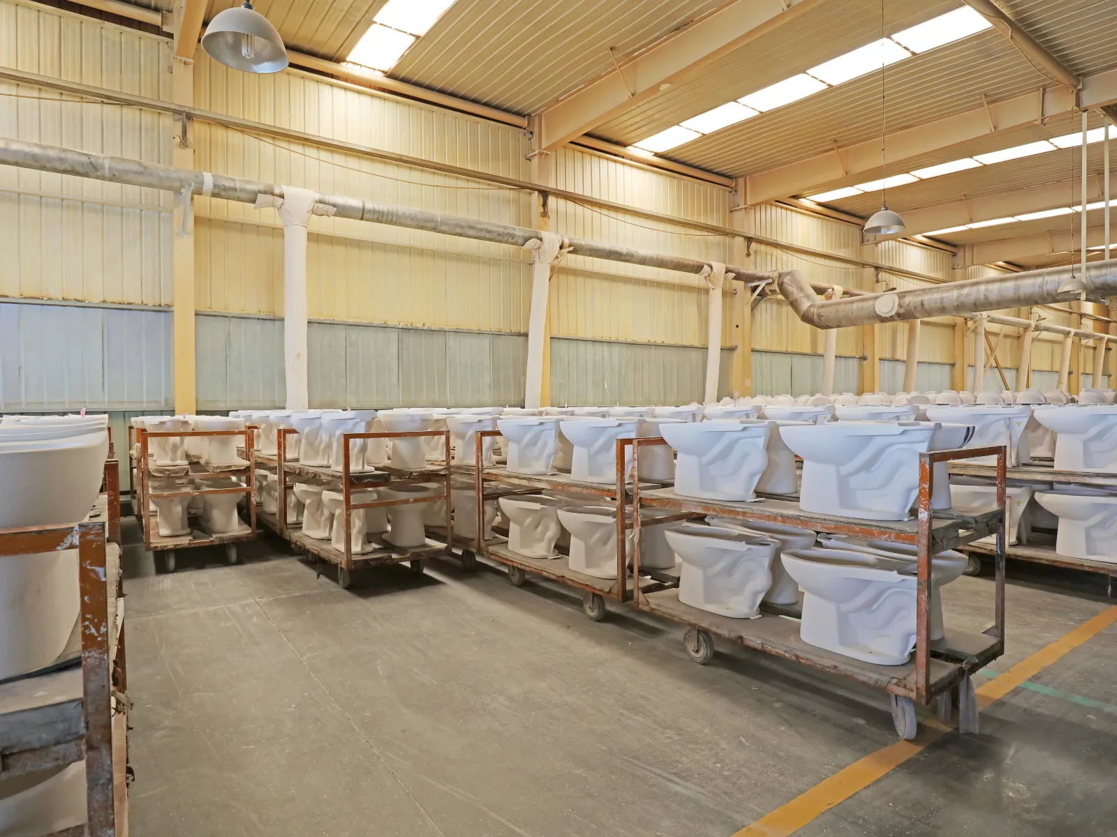 toilet bowls being manufactured in a ceramic factory