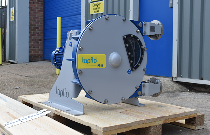 a peristaltic pump placed on a palette outside a warehouse